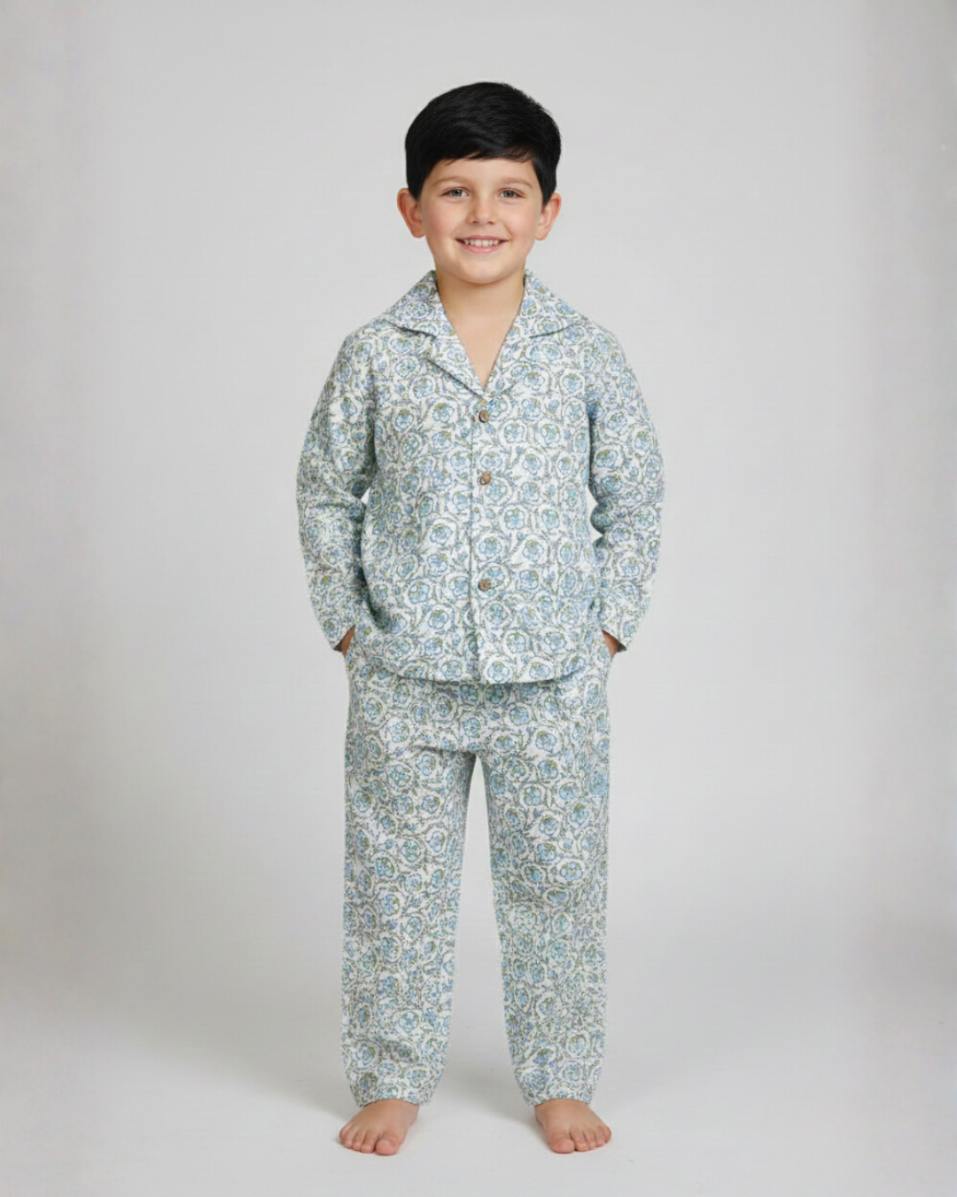 Child wearing a floral pajama set on a plain background