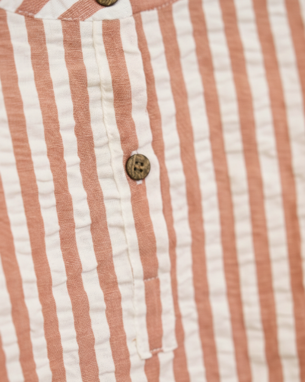 Close-up of a red and white striped fabric with buttons.