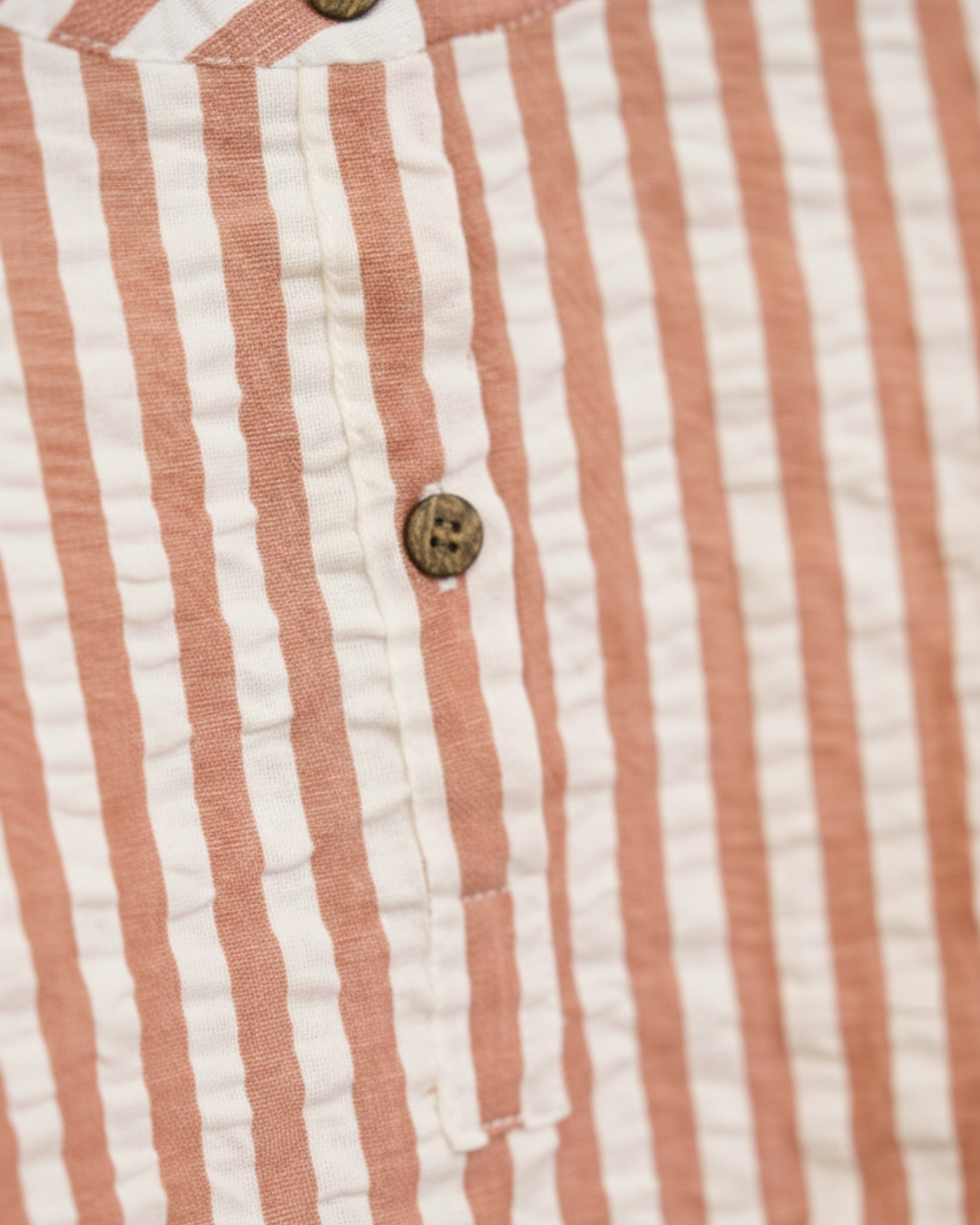 Close-up of a red and white striped fabric with buttons.