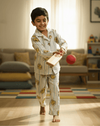 Child in pajamas holding a book in a living room