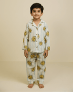 Child wearing a sun-patterned pajama set on a beige background
