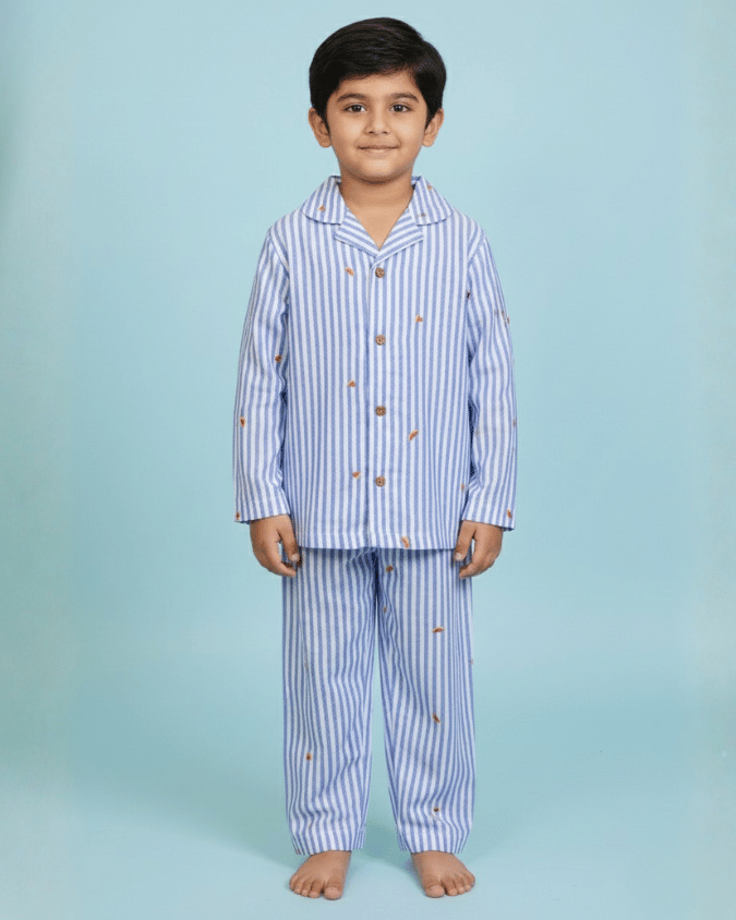 Child wearing a blue and white striped pajama set on a light blue background