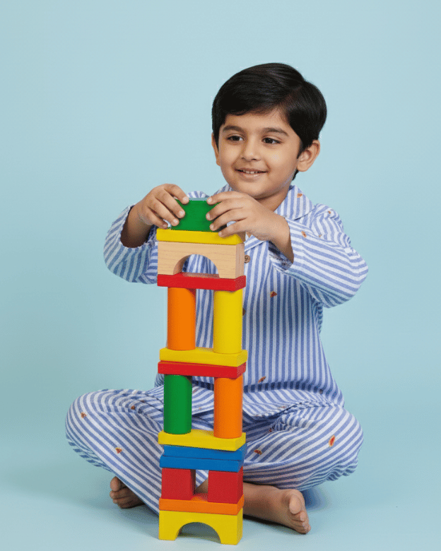 Child playing with colorful building blocks against a light blue background